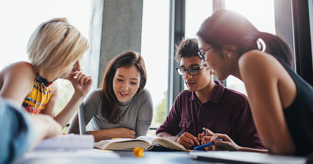 Diverse group of colleagues looks at documents together