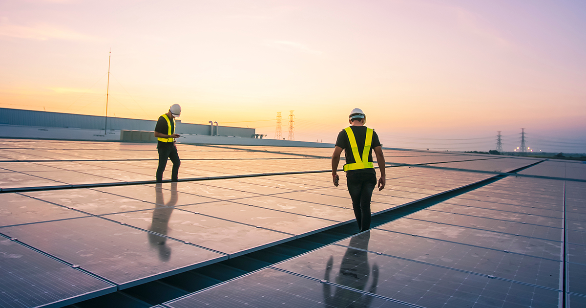 Men working on solar panels