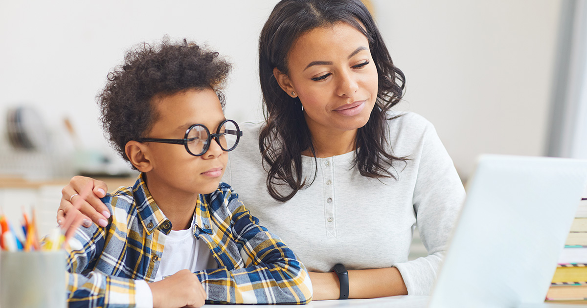 Female social worker helping child with his studies