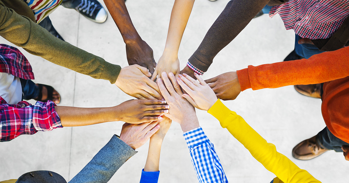 Team of diverse hands in a huddle