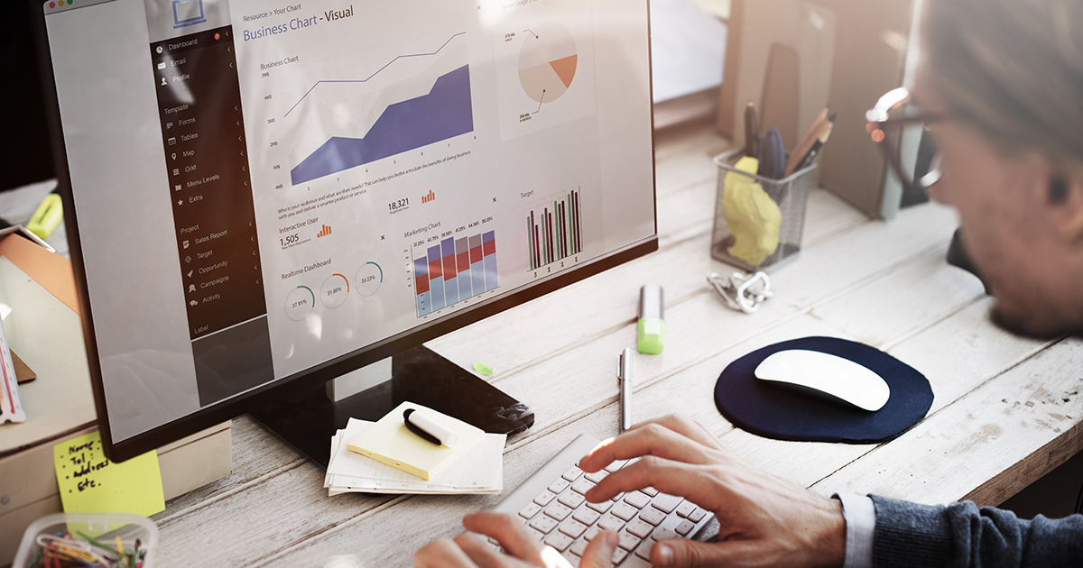 Man studying charts on computer