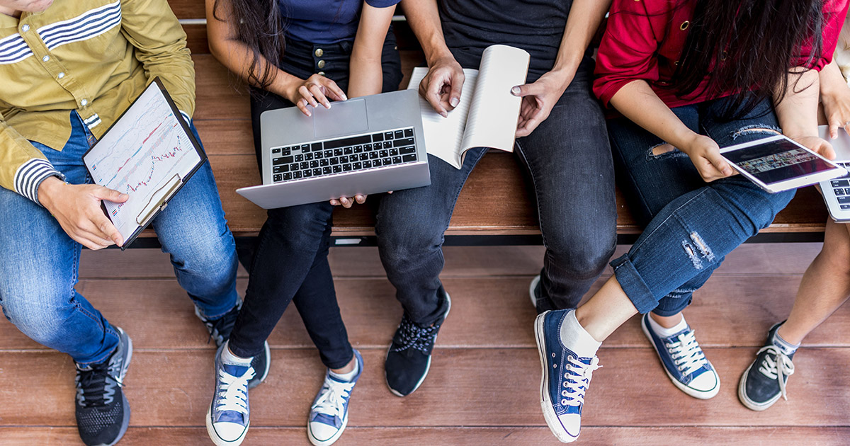 a group of students with laptops