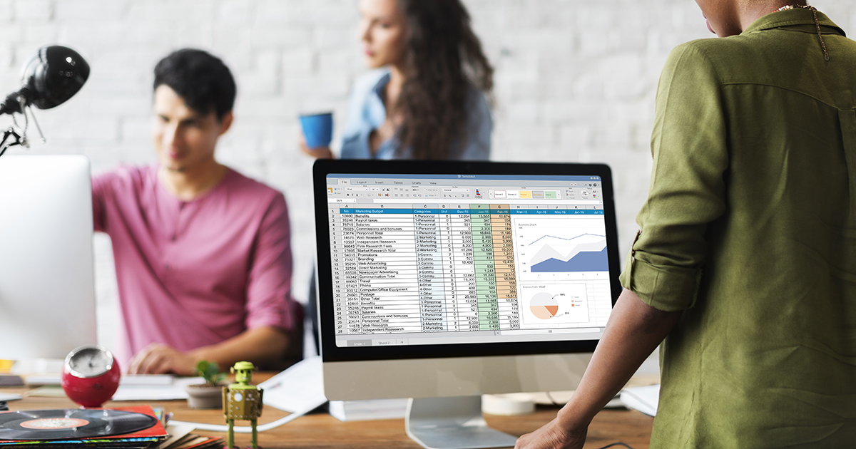 a women in front of the computer with data table in it