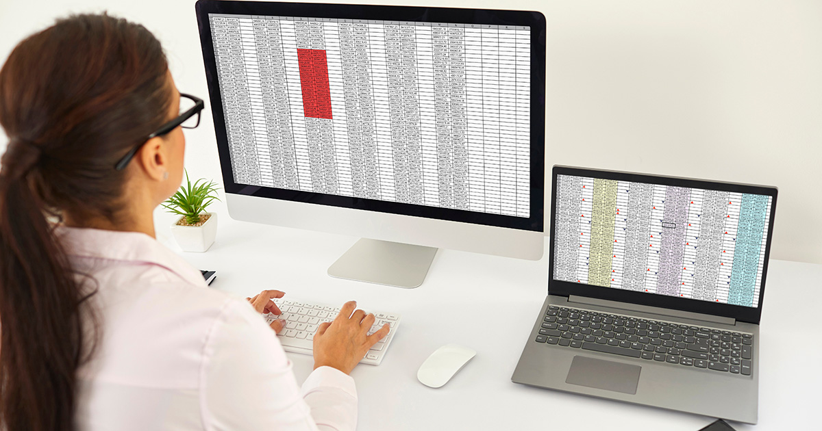 a women in fron of the monitor and computer looking at the data.