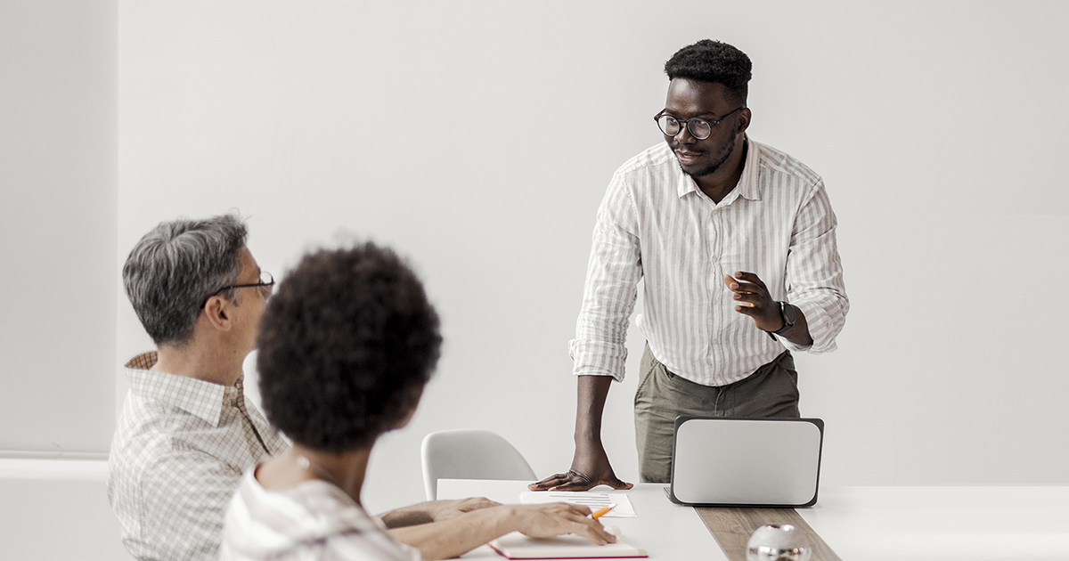 Black man gives presentation to colleagues