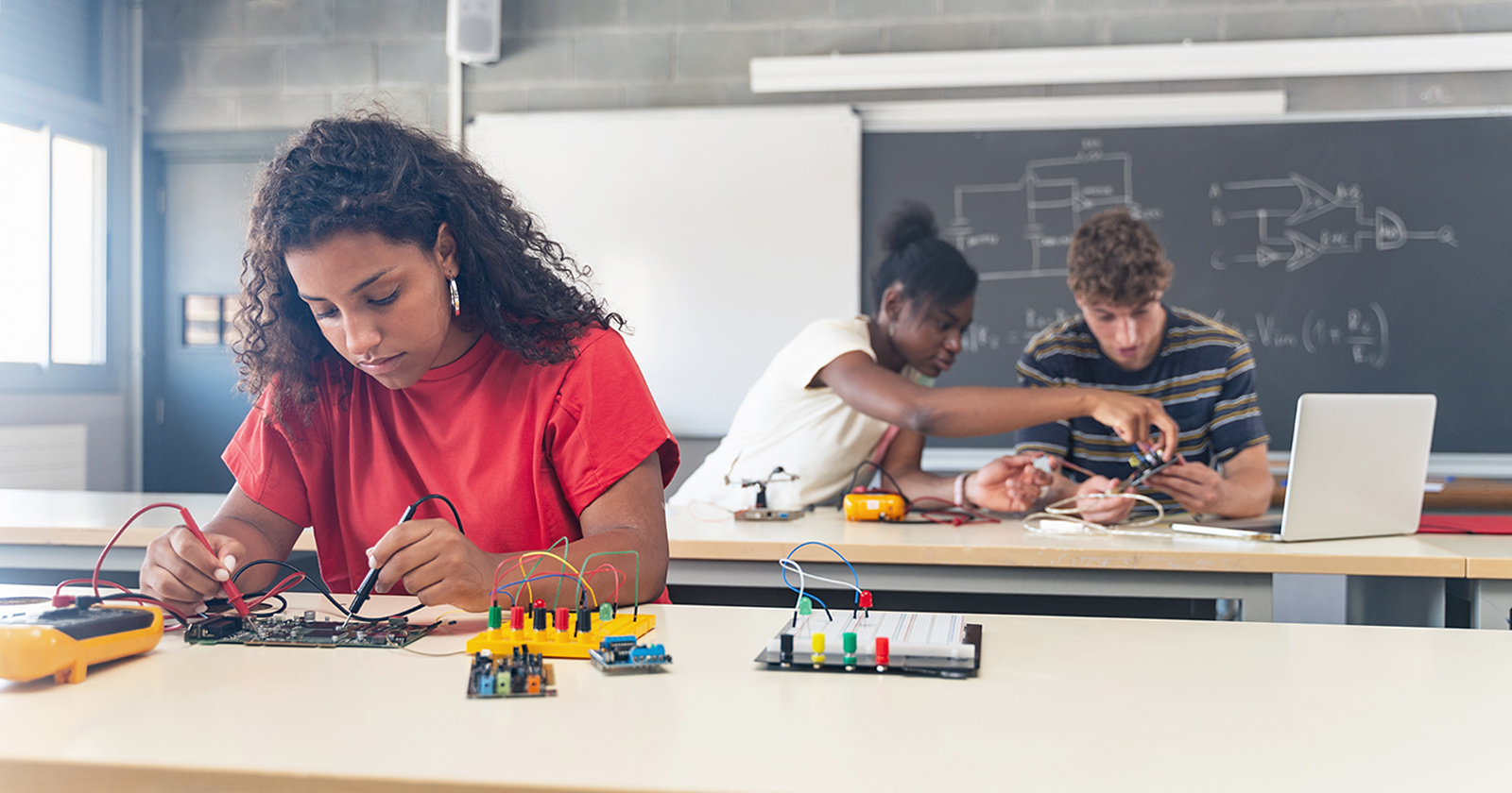 High school students working on circuit boards