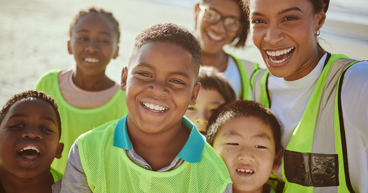 group of teenagers volunteer eco friendly beach