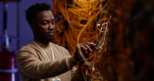 a man in front of many wires