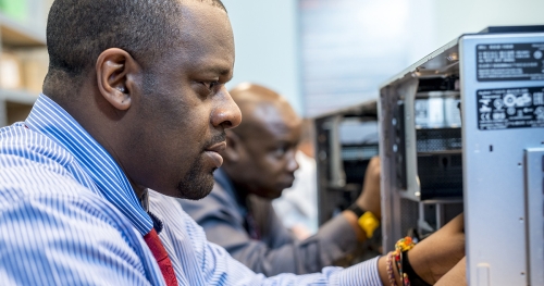 Men working on computer repair