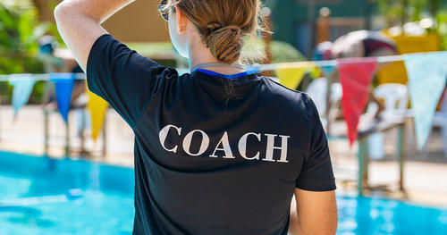 young girl a sweaming coach on a pool