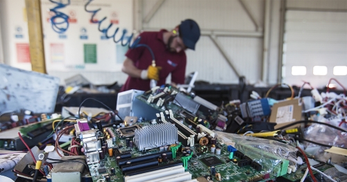 a man is working on computer parts