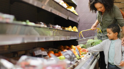 African-American mother and son shop for groceries