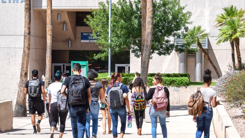 Group of college students walking on campus