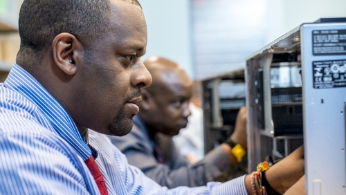 Men working on computer repair