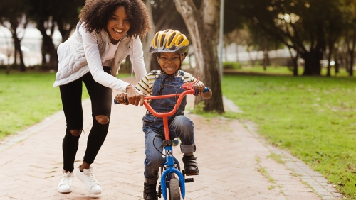 a mother with a little boy on a bicycle 