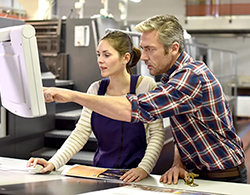 Man assisting woman with digital imaging