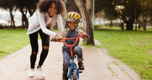 a mother with a little boy on a bicycle 