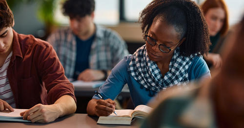 Diverse group of students taking notes in a college course