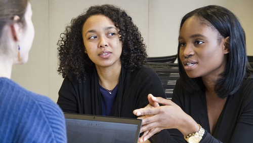 Group of multiracial women in discussion at the workplace